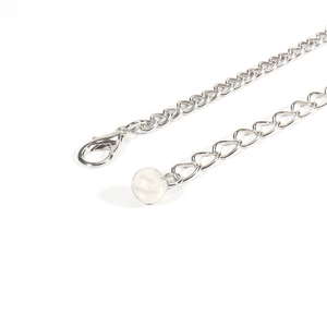 Detailed macro view of silver star moon waist chain extender with lobster clasp and bead