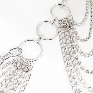 Detail of silver metal waist chain featuring multiple layers of rhinestones and tassels