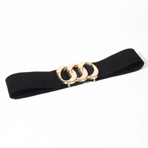 Detail of elastic waist belt with three interlocking gold metal rings on black fabric
