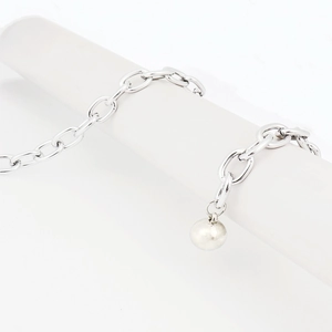 Macro detail of multilayer silver chain belt with shiny rhinestones and metal spheres