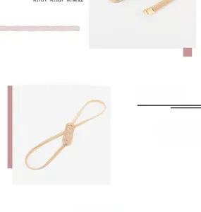 Detail of adjustable gold metal spring chain belt featuring interlocking double ring buckle