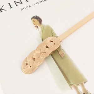 Elegant gold spring chain belt with infinity metal buckle over a minimalist background