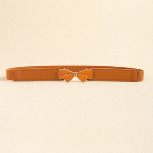 Detail of the elegant butterfly buckle on a brown elastic waist belt for dresses