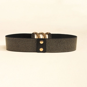 Detailed view of wide elastic waist belt with black gold fibers and metallic gold chain buckle