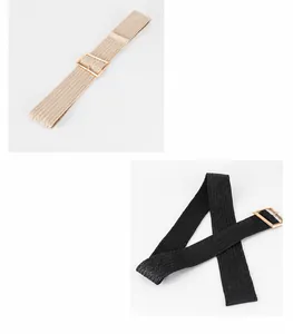 Detail view of woven elastic belts in beige and black with golden square metal buckles