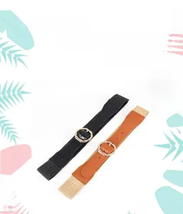 Detail of woven elastic waist belts in black and tan with bamboo-style gold metal buckles