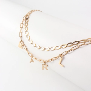 Detail view of gold double-layer chain waist belt with Eiffel Tower and KRL charms