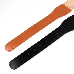 Close-up of wide waist belts featuring woven texture and smooth leather with round buckles