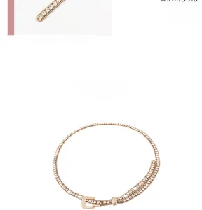 Detail of adjustable golden rhinestone waist chain belt with sparkling buckle for women
