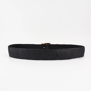 Close-up of black woven leather belt with intricate intrecciato pattern and gold metal buckle
