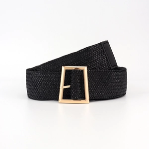 Detailed macro view of black elastic woven belt with golden rectangular pin buckle