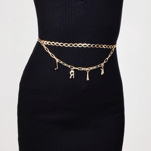Close-up of double-layer golden waist chain with Eiffel Tower and letter charms