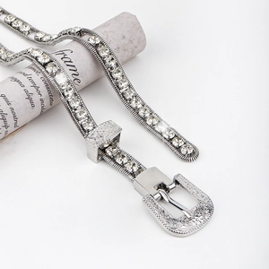 Close-up of sparkling rhinestone waist chain with vintage engraved silver western buckle
