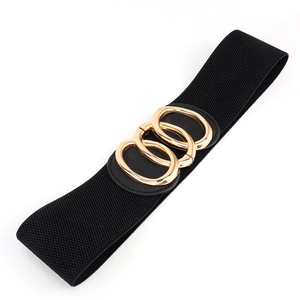 Close-up of women's black elastic wide belt with three interlocking gold oval buckles