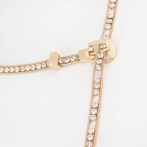 Detail of gold rhinestone waist chain featuring vintage engraved buckle and double rows