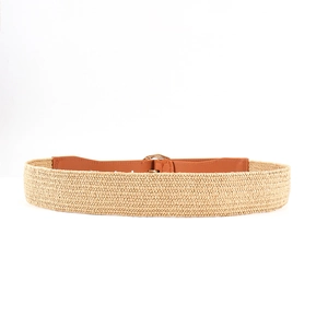 Detail of bohemian woven waist belt with brown leather patch and gold hollow metal buckle