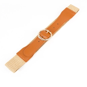 Detail of bohemian wide waist belt with brown faux leather, straw elastic, and bamboo buckle