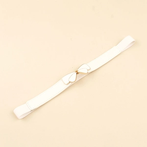 Close-up of white elastic waist belt featuring a gold-edged bow buckle for dresses