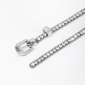 Close-up of silver metal waist chain with rhinestone inlay and vintage engraved buckle