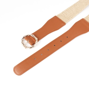 Detail of bohemian belt featuring an octagonal bamboo-style metal buckle and woven elastic