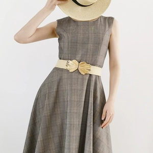 Women's plaid dress with cream woven elastic belt featuring a large gold butterfly buckle