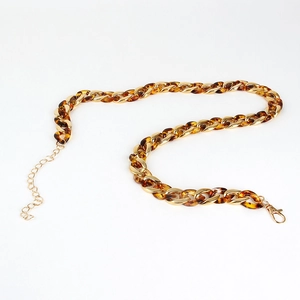 Detail of leopard print acrylic and gold metal chain links with lobster clasp