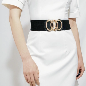 Detail of a wide black elastic waist belt with three interlocking gold metal rings