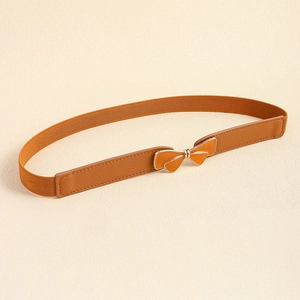 Detail of warm brown elastic waist belt with gold-edged bow buckle for dresses