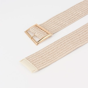 Detailed macro view of champagne gold woven elastic belt with polished golden buckle