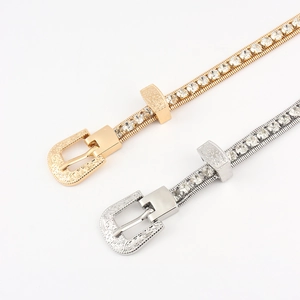 Detail of rhinestone waist chains with vintage engraved buckles in gold and silver
