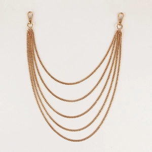 Detail view of five-layer gold curb chain accessory with secure lobster clasps on both ends