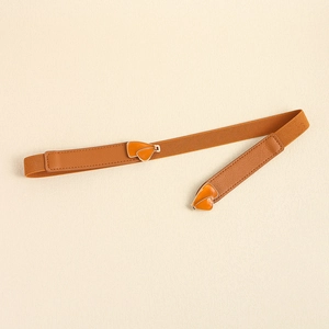 Detail of thin orange elastic waist belt with gold heart-shaped drip oil buckle clasp