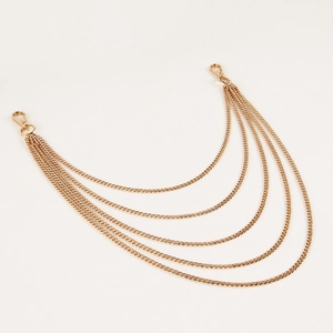 Detail of five-layer gold punk waist chains with lobster clasps and polished metal links
