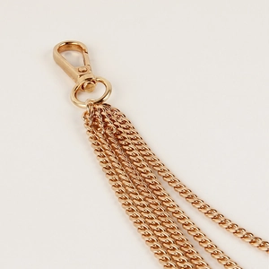 Detailed macro view of five-layer gold punk waist chain with polished lobster clasp