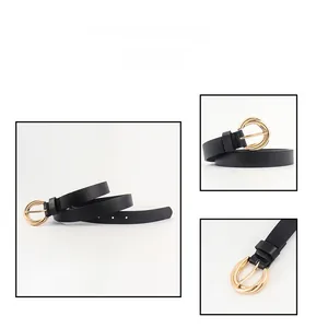 Detail of minimalist black leather belt featuring elegant triple golden ring metal buckle