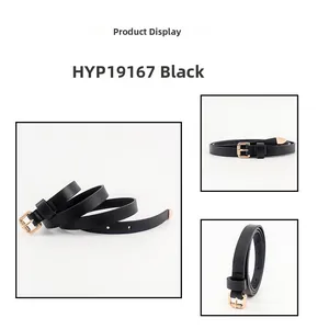 Detail of slim black leather belt featuring a gold metal pin buckle and tipped end