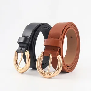 Minimalist black and brown leather belts with large vintage gold round metal buckles
