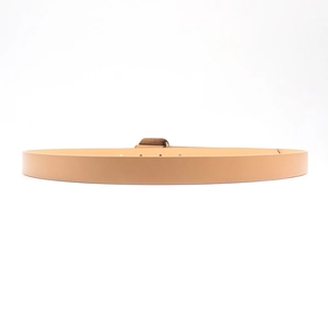 Close-up of slim tan PU leather belt with bronze square buckle and adjustable holes