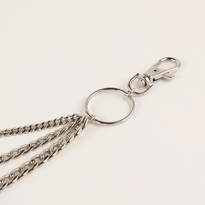 Macro detail of three-layered silver hip hop trouser chains with lobster clasp connector