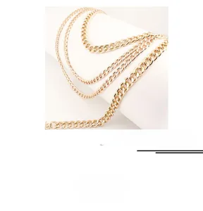 Detailed view of triple-layered golden metal waist chain with moon and star pendants