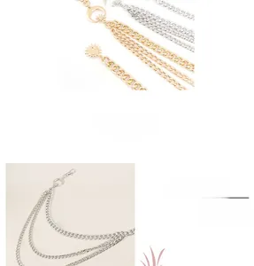 Detail view of multi-layer gold chain belt featuring sun, moon, and star charms
