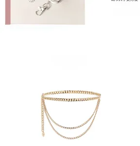 Detail of multi-layer golden waist chain with moon star pendants and adjustable lobster clasp