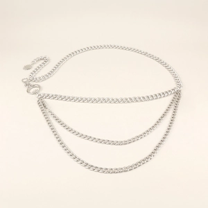 Detail of silver multi-layer waist chain featuring moon and star pendants with lobster clasp