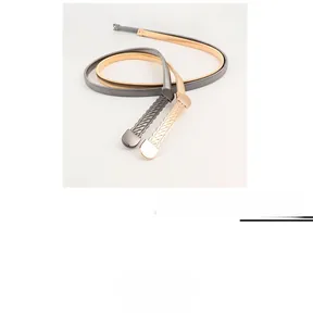 Detail of gold and gunmetal waist chains showing intricate metal woven textures