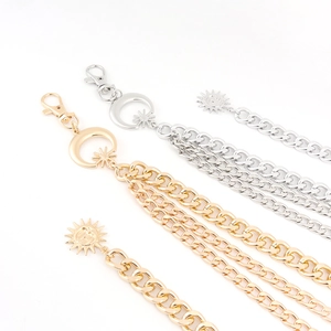 Detailed macro of gold and silver sun and moon star charms on triple metal waist chains