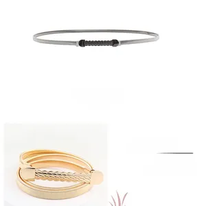 Detail view of stylish wavy metal buckle and elastic snake chain waist belt for women