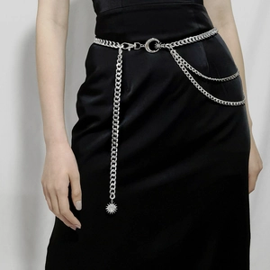 Three-layer silver metal waist chain with moon and sun pendants on black dress