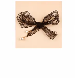 Detail of elegant black lace waist chain with delicate white pearl pendants and golden beads