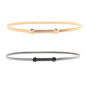 Close-up of flexible metal chain belts with elegant wavy textured buckle heads
