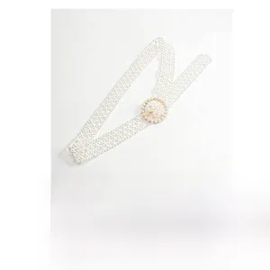 Detailed close-up of an elegant pearl waist chain featuring a round pearl decorative buckle